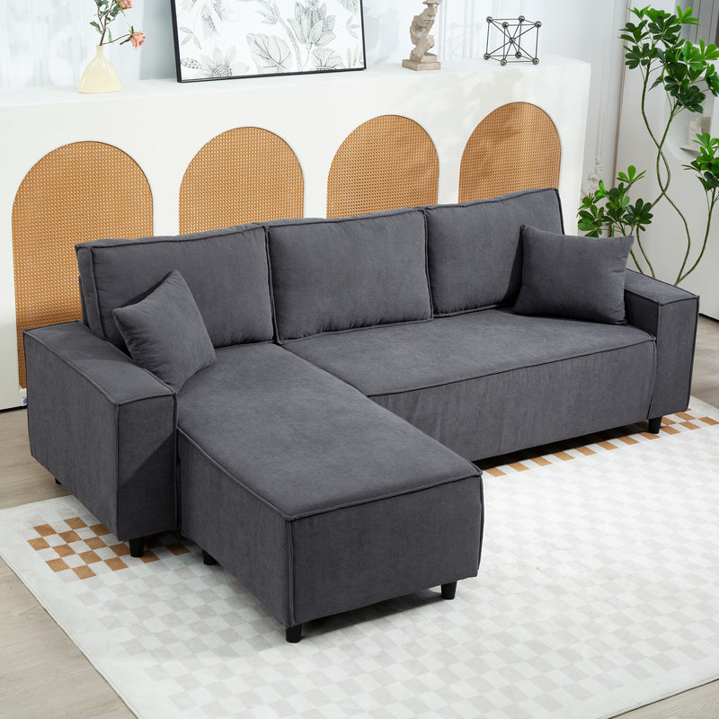 Gray sectional sofa in a living room setting with decorative elements.