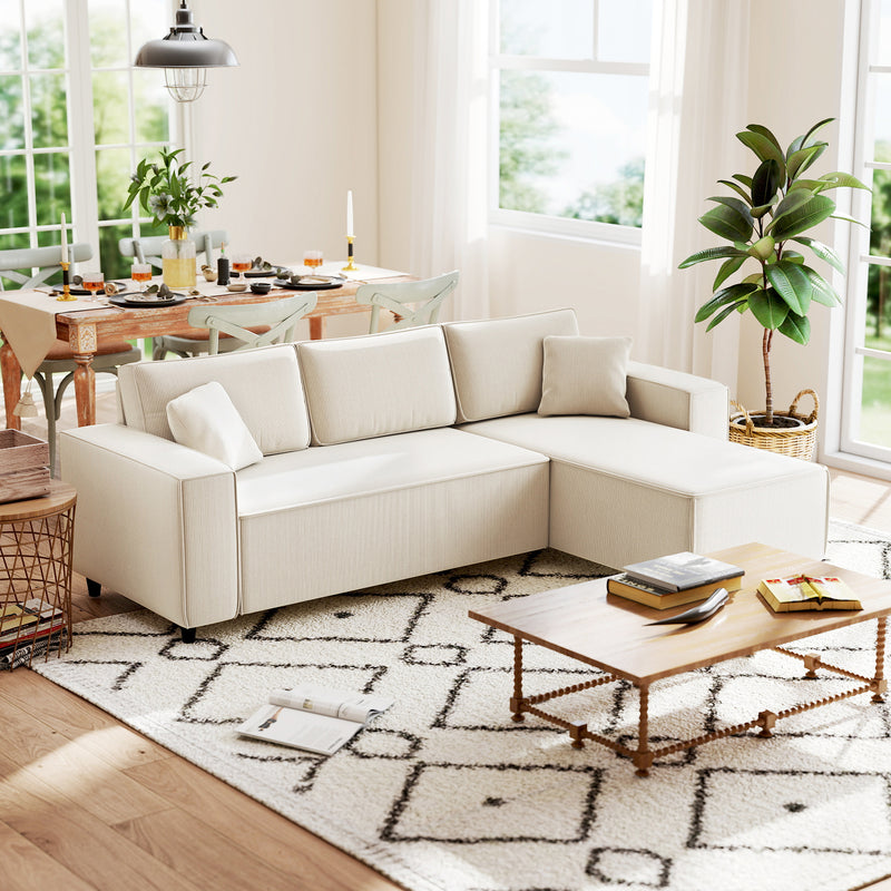Living room with a beige sectional sofa, coffee table, and dining area.