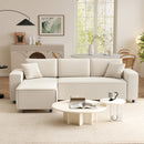 Beige sectional sofa in a living room with a coffee table and decor items.