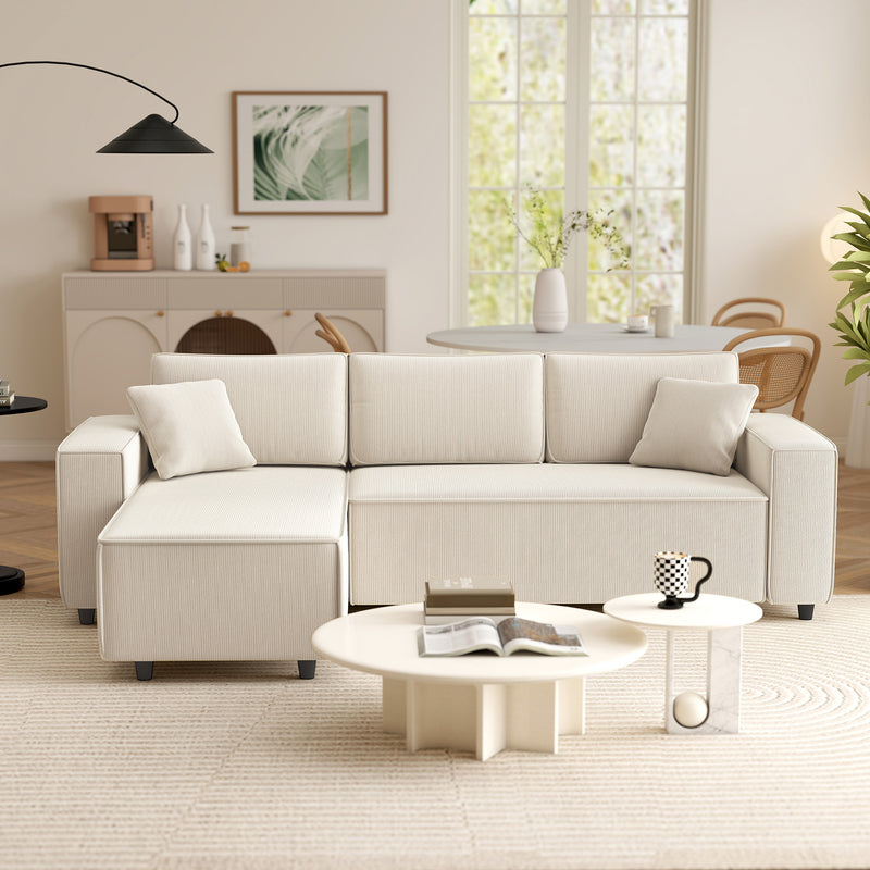 Beige sectional sofa in a living room with a coffee table and decor items.